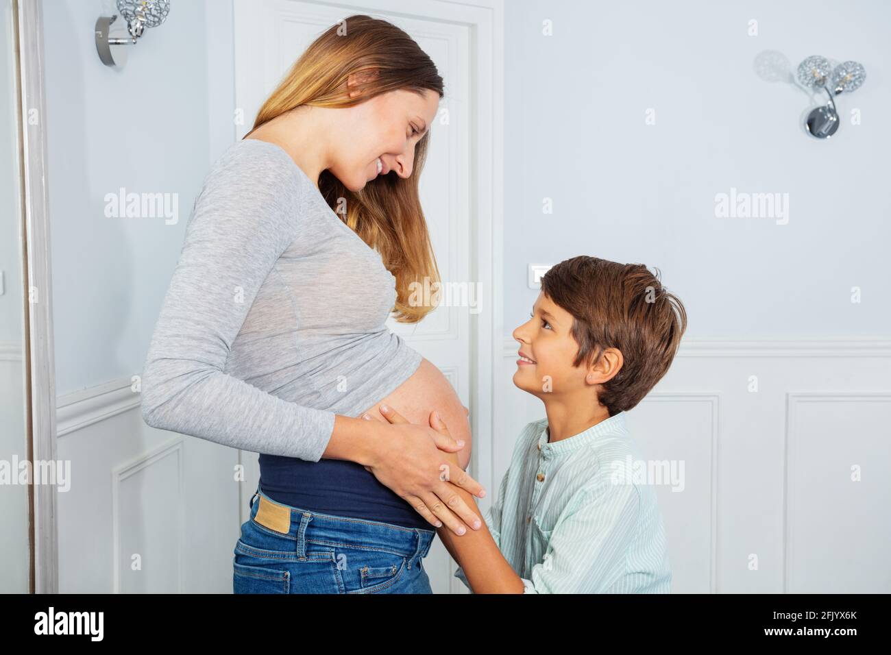 Boy touch pregnant belly of mother, look with love Stock Photo Alamy