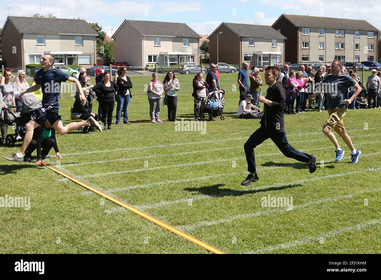 Muirhead Primary School Sports Day The Dads rush to the line Stock Photo