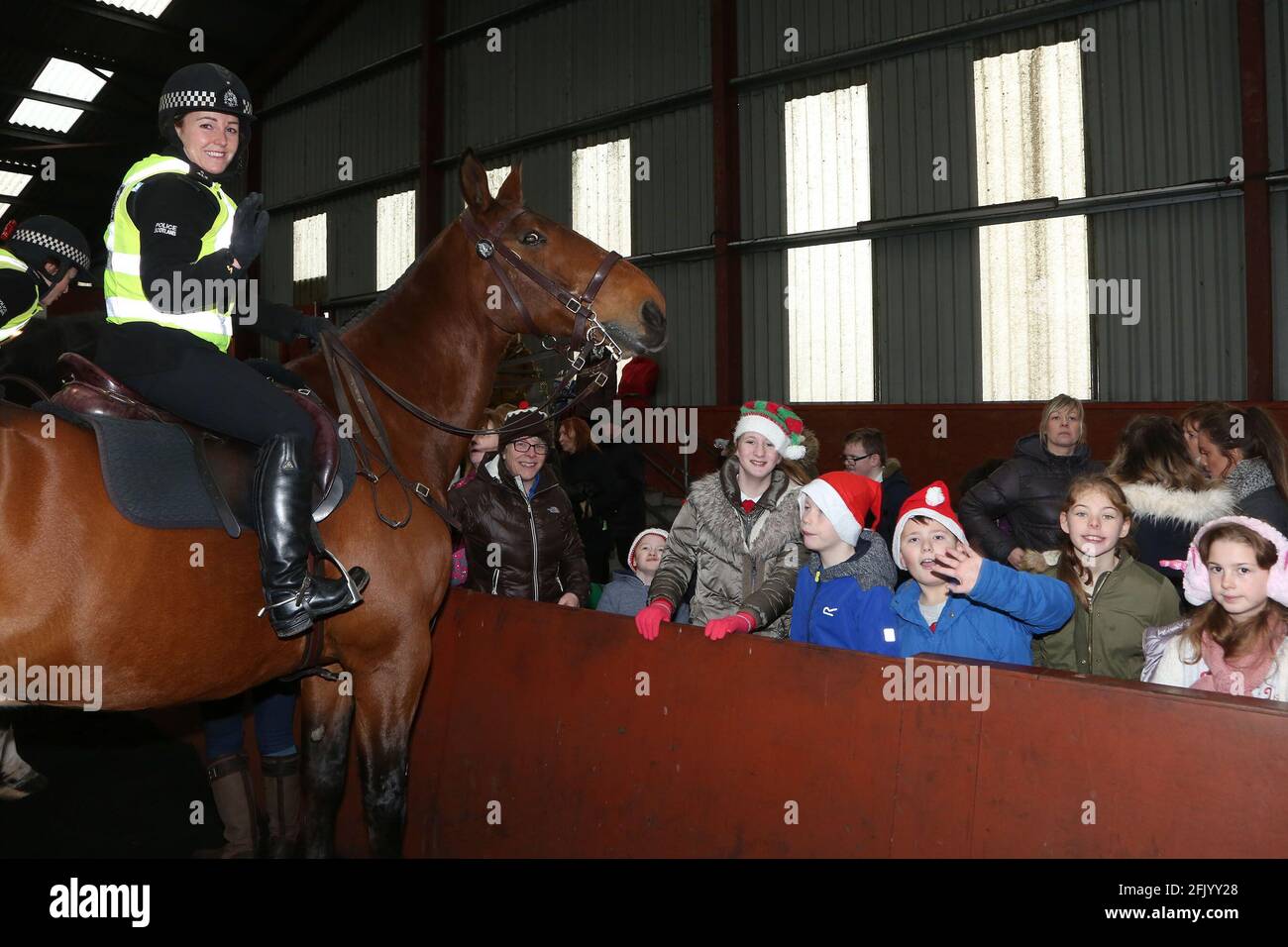 Ayrshire Equitation Centre Riding for the diabled. Children from various schools aroud Ayrshire came to meet Santa collected their rosettes and  the opportunity to meet horses from Police Scotland  Police officer Vicky Graham on Orcadia with children from Park School Stock Photo