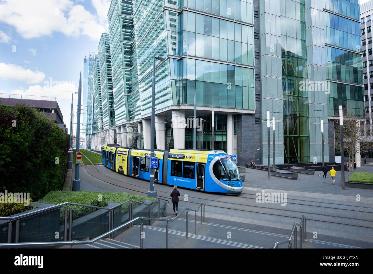 A West Midlands Metro tram passes by One Snowhill in Birmingham, UK Stock Photo