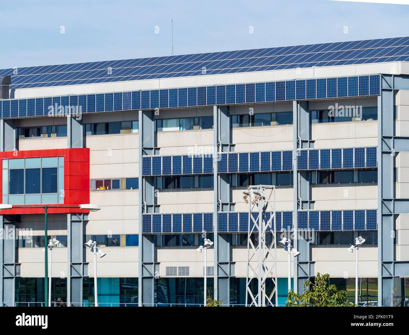 Façade of building with solar panels for electricity production Stock Photo
