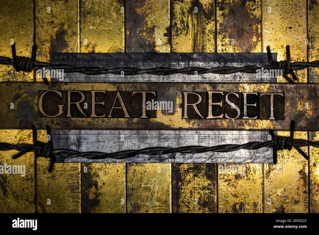 Great Reset text lined with barbed wire on vintage textured silver grunge copper and gold background Stock Photo