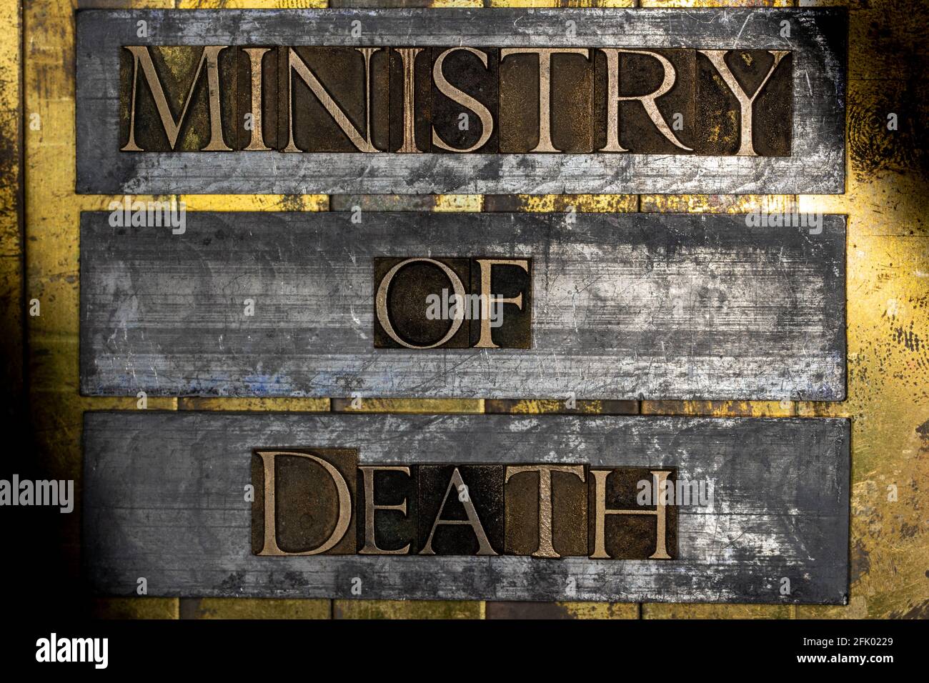 Ministry of Death text on vintage textured silver grunge copper and gold background Stock Photo