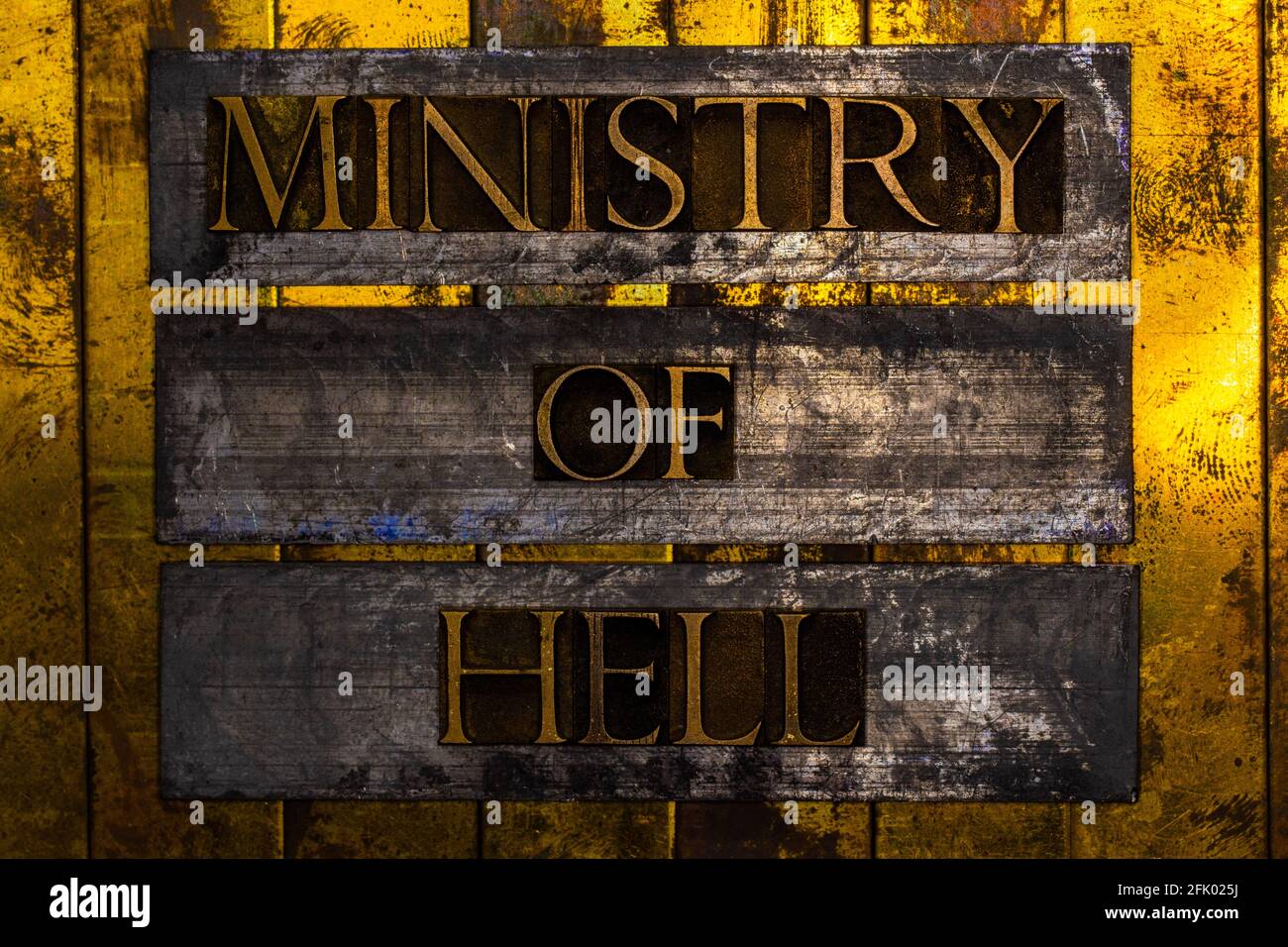 Ministry of Hell text on vintage textured silver grunge copper and gold background Stock Photo
