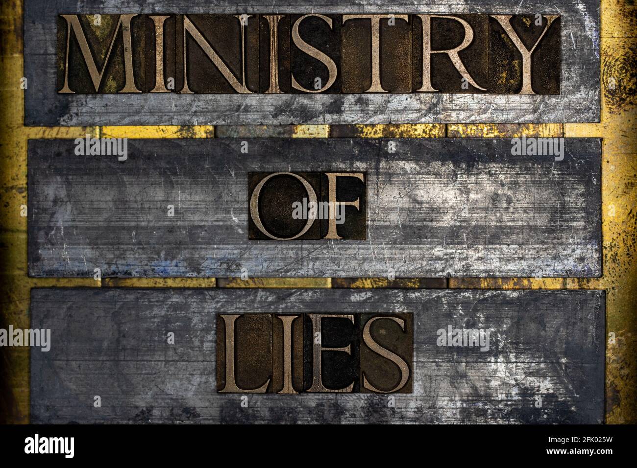 Ministry of Lies text on vintage textured silver grunge copper and gold background Stock Photo