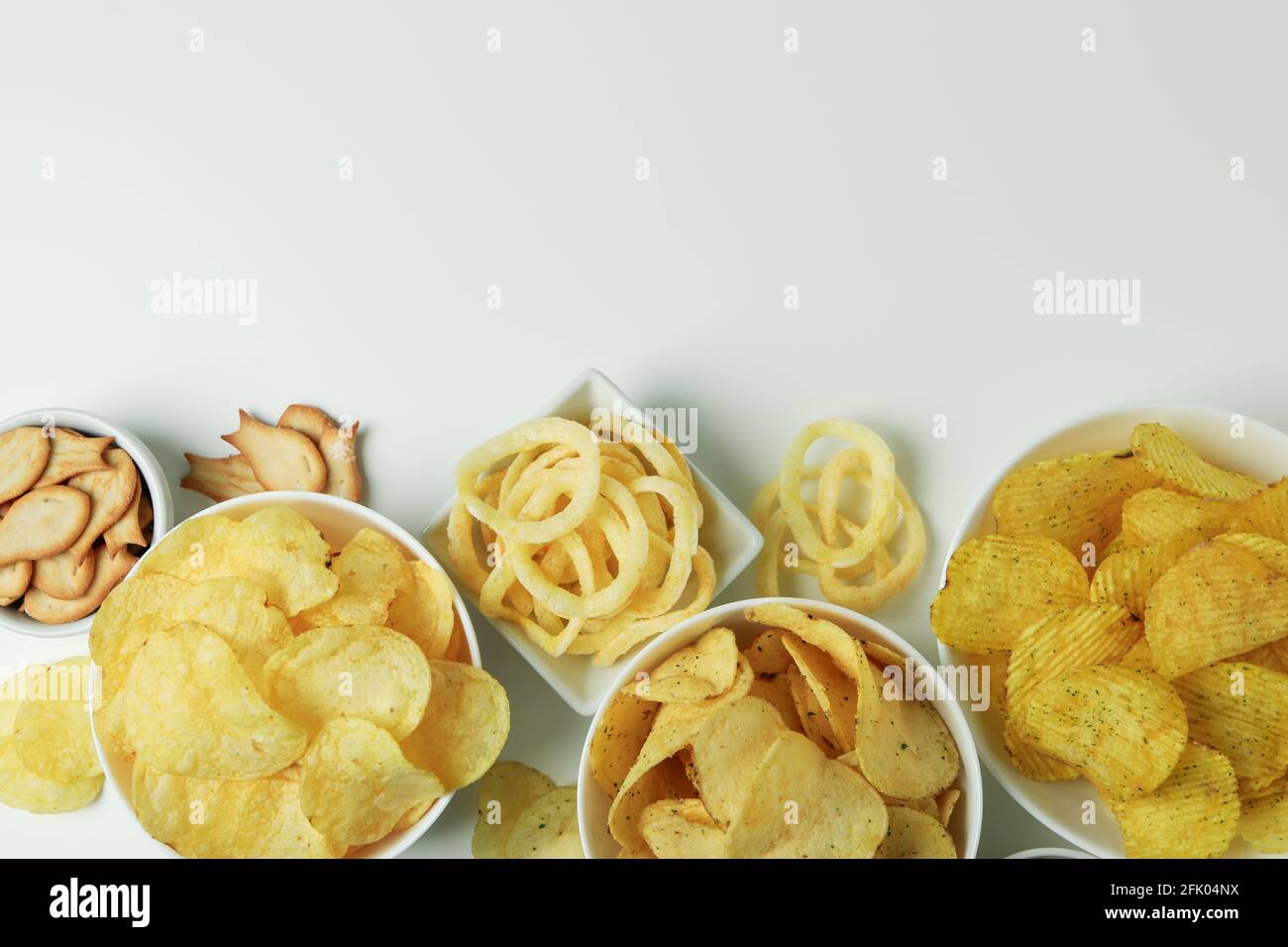 Bowls with different snacks on white background Stock Photo - Alamy
