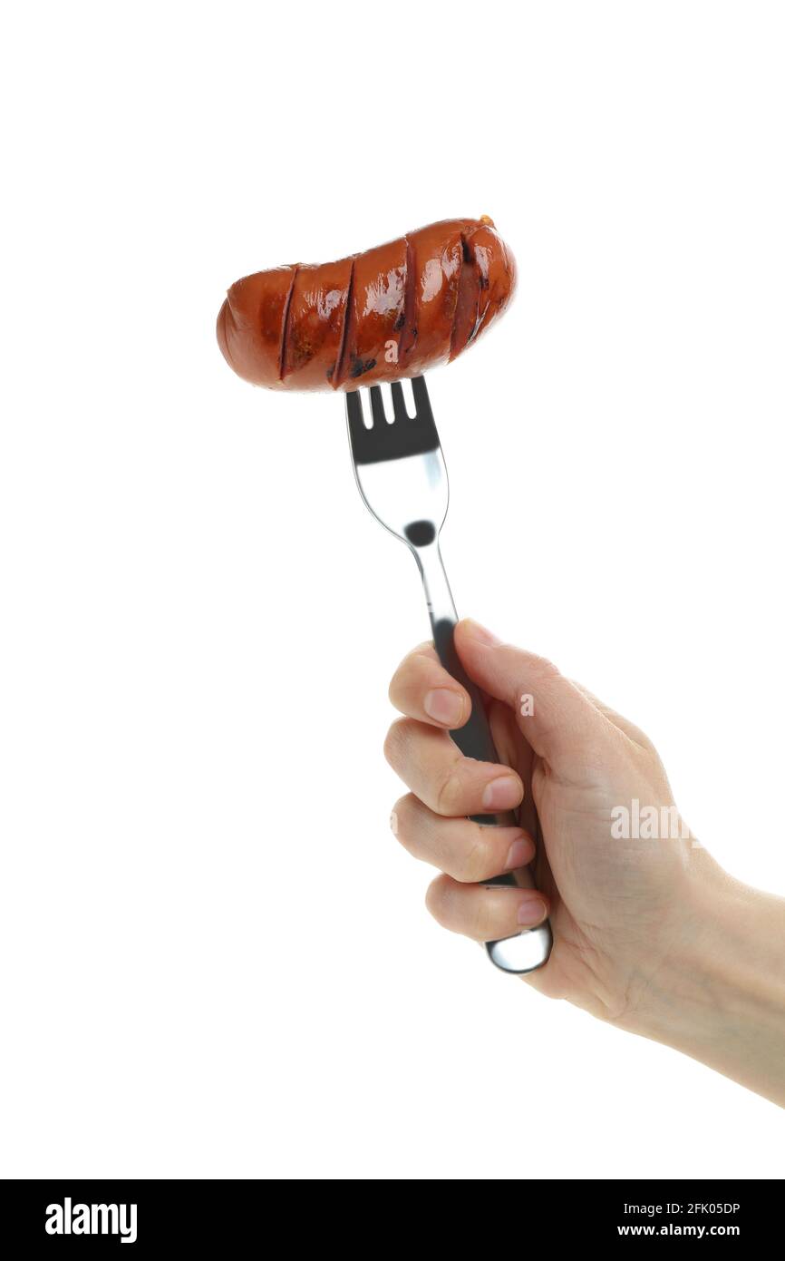 Female hand hold fork with grilled sausage, isolated on white background Stock Photo