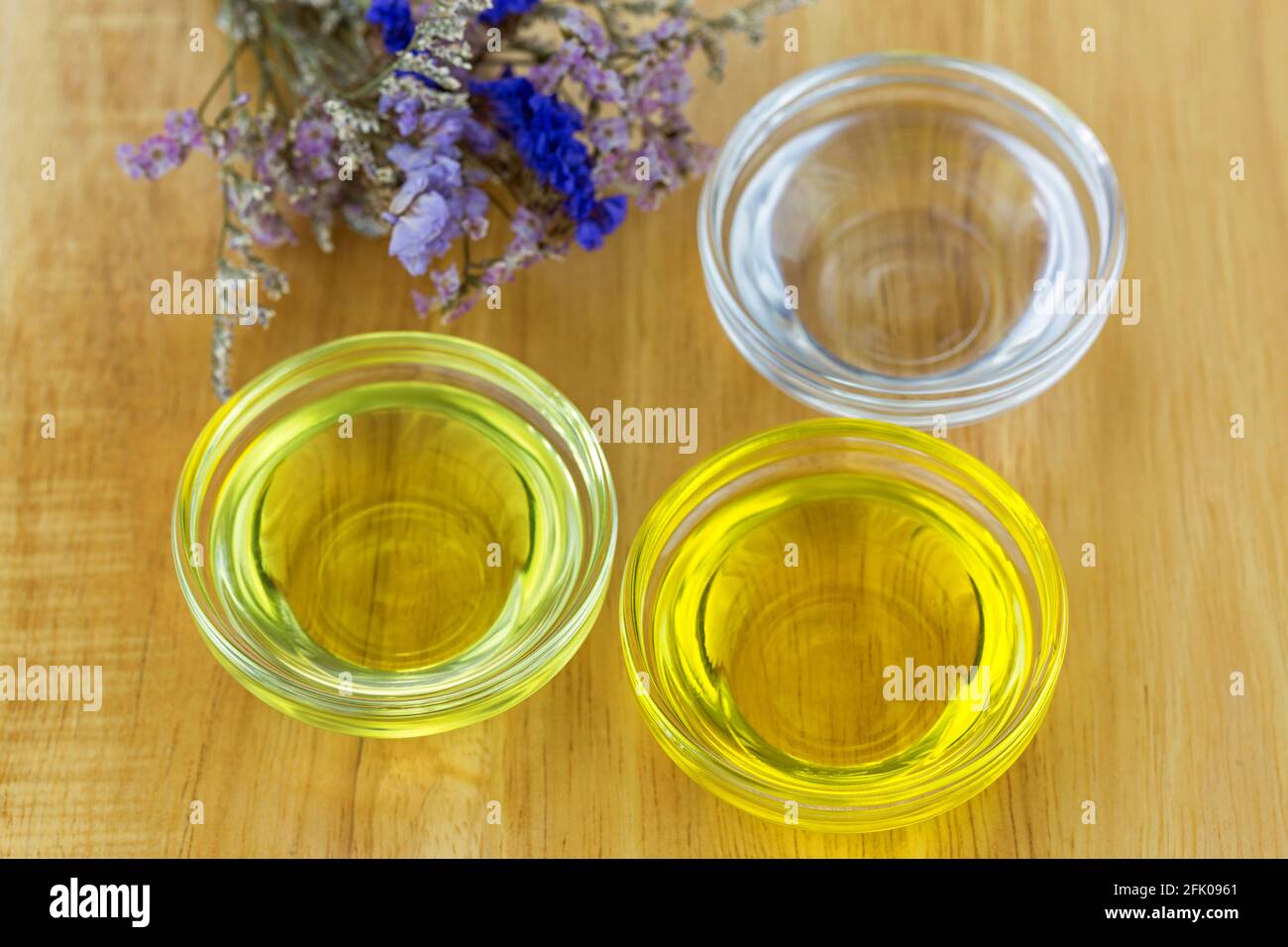 Bowl of different organic oil - cold pressed Coconut oil, Jojoba Oil, Caster oil to make homemade skin beauty product Stock Photo