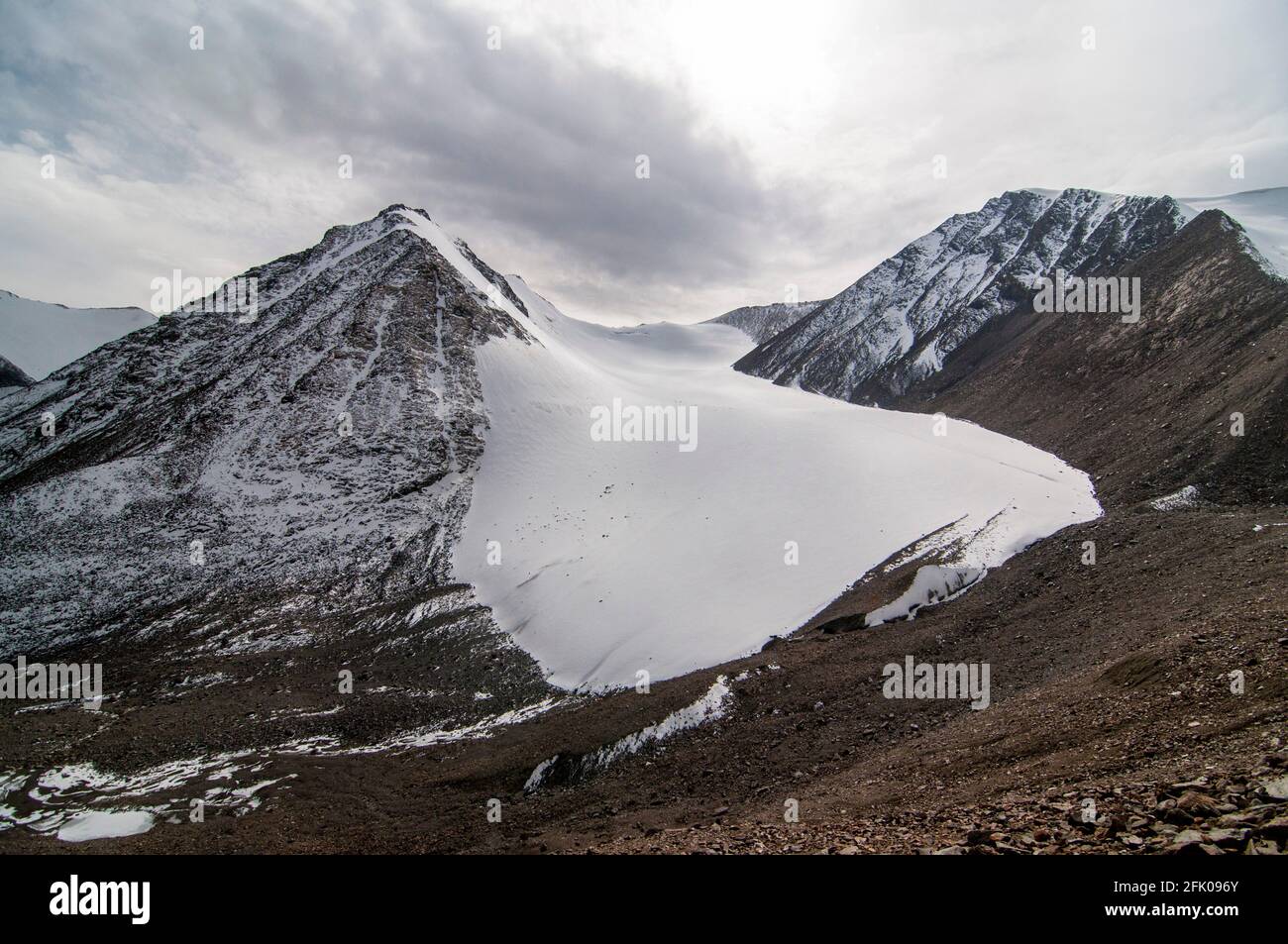 Fresh snow covers the top of the Xinjiang Tianshan No 1 Glacier, where ice and snow have been compacted over many years onto the rocky slopes of the Tianshan mountains in Eastern Xinjiang, China, PRC. © Time-Snaps Stock Photo