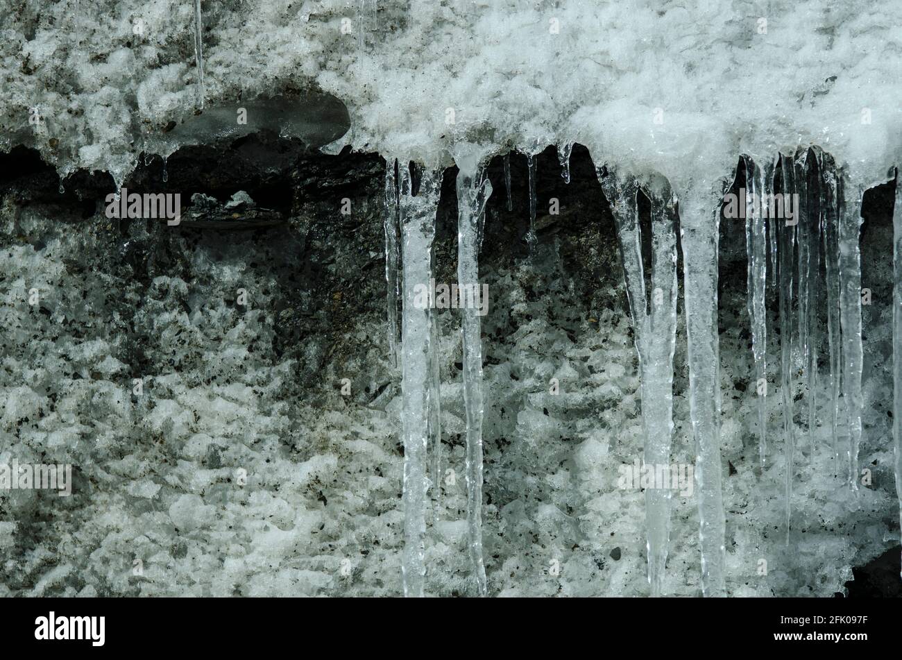 Icicles are formed where melted snow and ice drips off the edge of the Xinjiang Tianshan No 1 Glacier, where ice and snow have been compacted over many years onto the rocky slopes of the Tianshan mountains in Eastern Xinjiang, China, PRC. © Time-Snaps Stock Photo