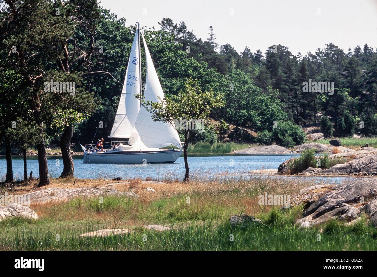 Boat sailing through the stone door archipelago, nykoping, sodermanland