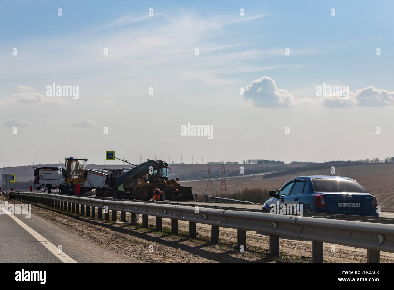 Interstate Highway Ufa - Kazan M7, Russia - Apr 23th 2021. Repair of one of the lanes of the auto road. Special equipment for laying asphalt Stock Photo