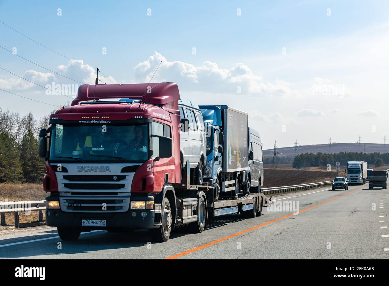 Interstate Highway Ufa - Kazan M7, Russia - Apr 23th 2021. The Scania truck of the AGAT-LOGISTIC.RU company transports medium-sized commercial vehicle Stock Photo