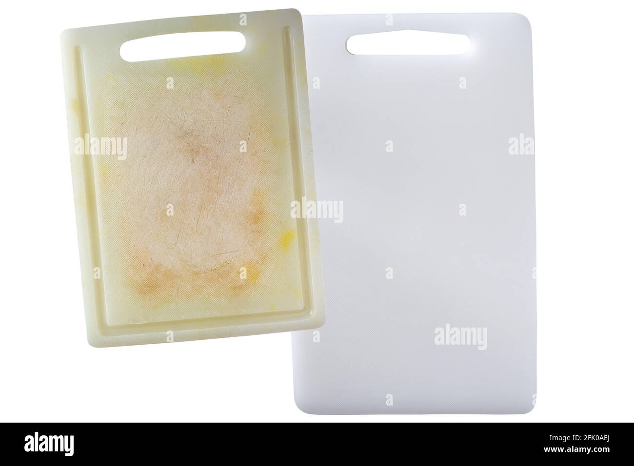 New clean and dirty white plastic cutting board with dark stains