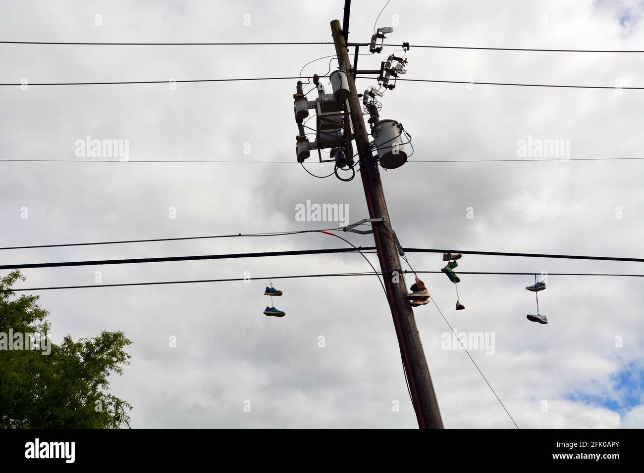 Running shoes dangle from the power lines outside of a running shoe