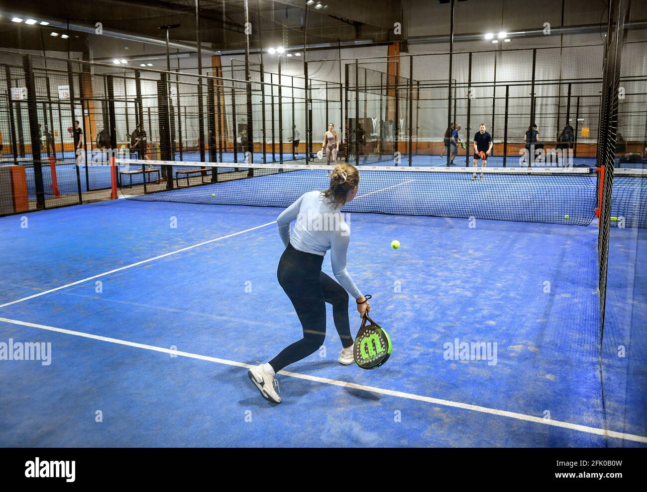 Padel is a racquet sport that combines the elements of tennis, squash and  badminton. Padel is the world's fastest growing sport. Woman girl playing  padel. A woman, girl playing padel. Photo: Anders