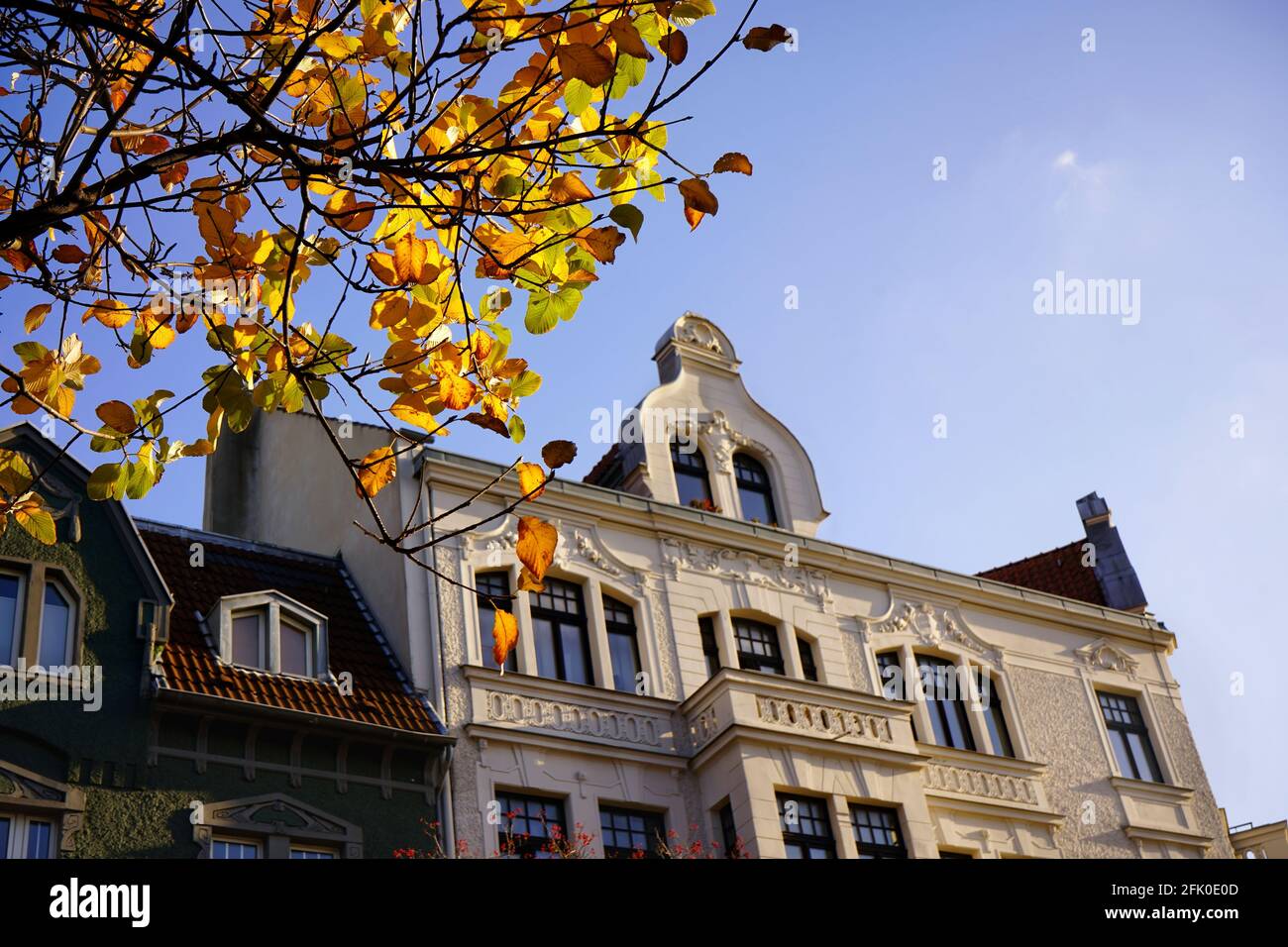 Facade of a private house in Düsseldorf, district of Oberkassel, with autumn tree in front. This district is located near Rhine river. Stock Photo