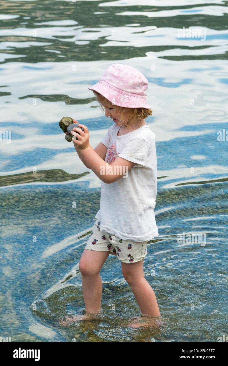 Girl Aged 4 Years Old Kid With Sun Hat Protection Hats Kids Child Play With Stone Pebbles In Conjux On Beside Lake Du Bourget Lac Du Bourget France 101 Stock Photo Alamy