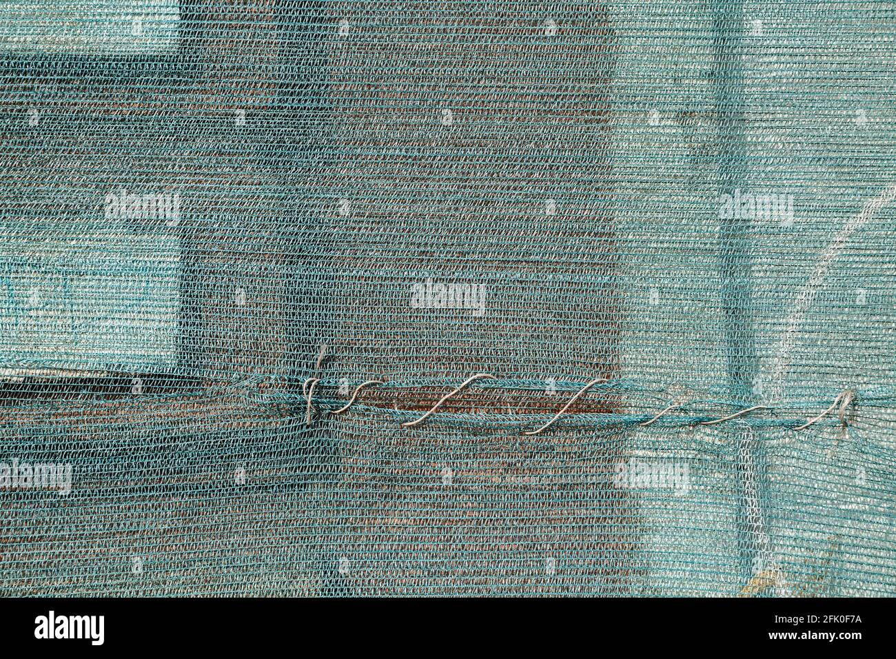 Plastic blue grid on the abandoned house facade Stock Photo