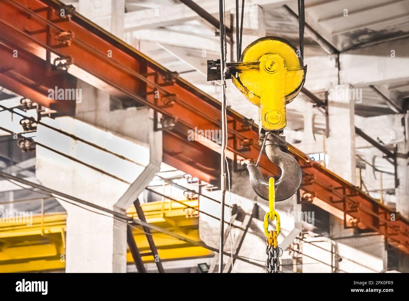 Overhead crane lifting hook on the background of an industrial