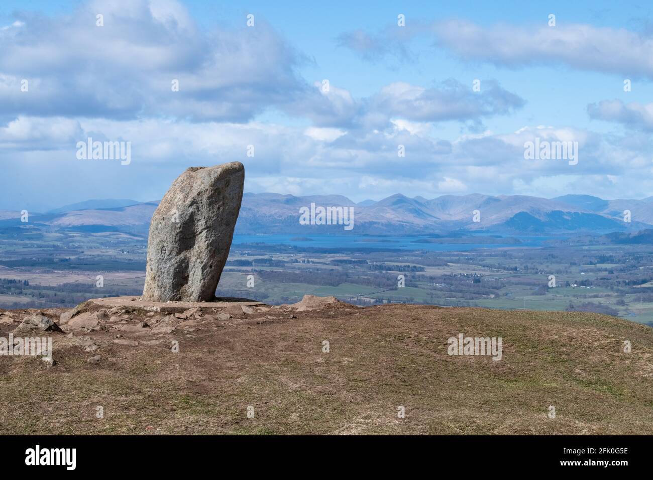 Dumgoyne summit marked by a standing stone overlooking Loch Lomond and Loch Lomond and the Trossachs National Park, Stirling, Scotland, UK Stock Photo