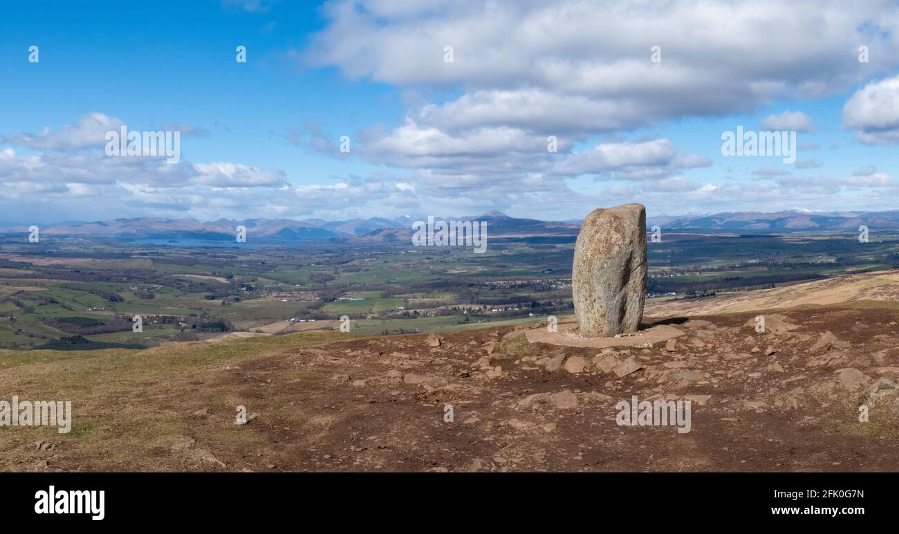 Dumgoyne summit marked by a standing stone overlooking Loch Lomond, Ben Lomond and Arrochar Alps, Stirling, Scotland, UK Stock Photo
