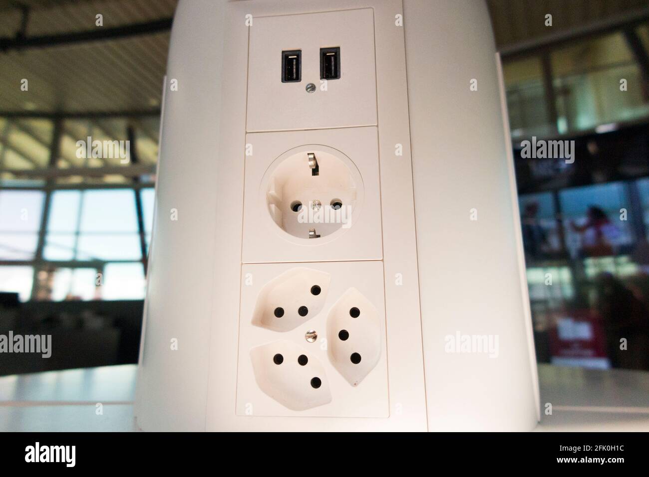 Array of electric charge plug sockets ( inc USB socket ) for charging the  electrical batteries in mobile devices of passengers / passenger. Geneva  Cointrin airport, Switzerland Stock Photo - Alamy