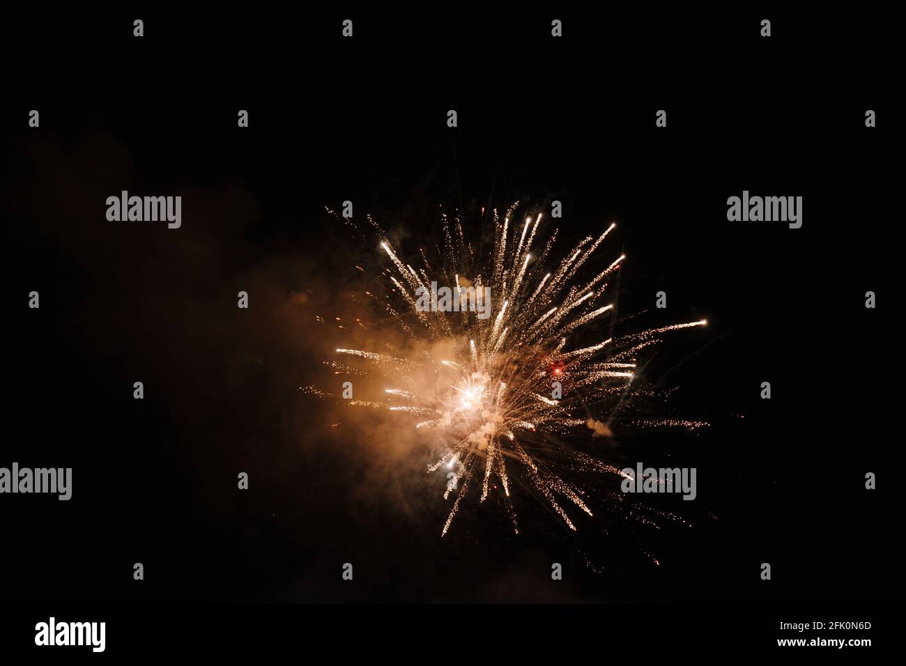 Colored fireworks explode in the dark sky Stock Photo