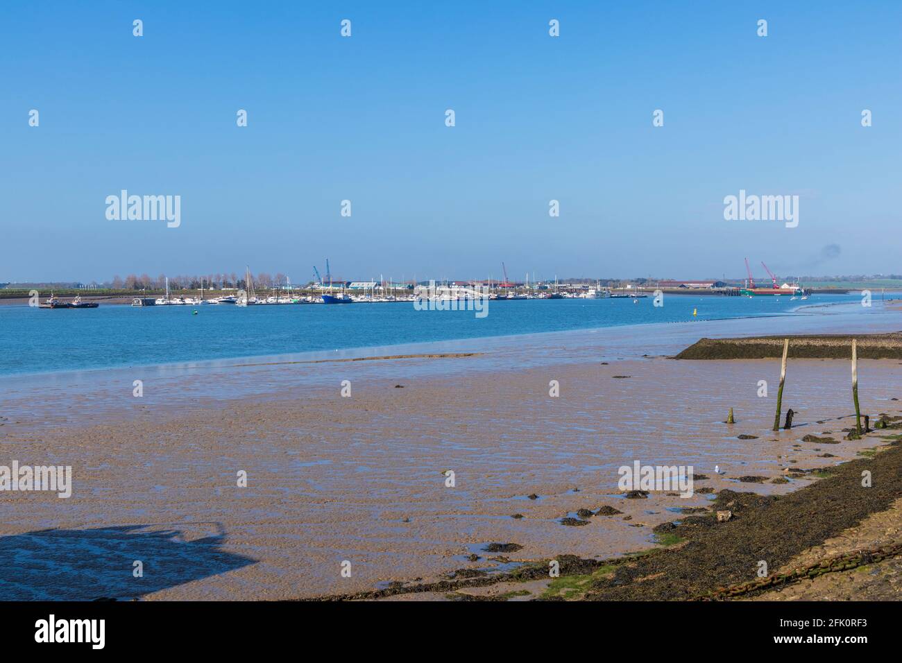 Low Tide at Burnham-on-Crouch Looking Across River Crouch to Moored Boats at Baltic Wharf at Canewdon Stock Photo
