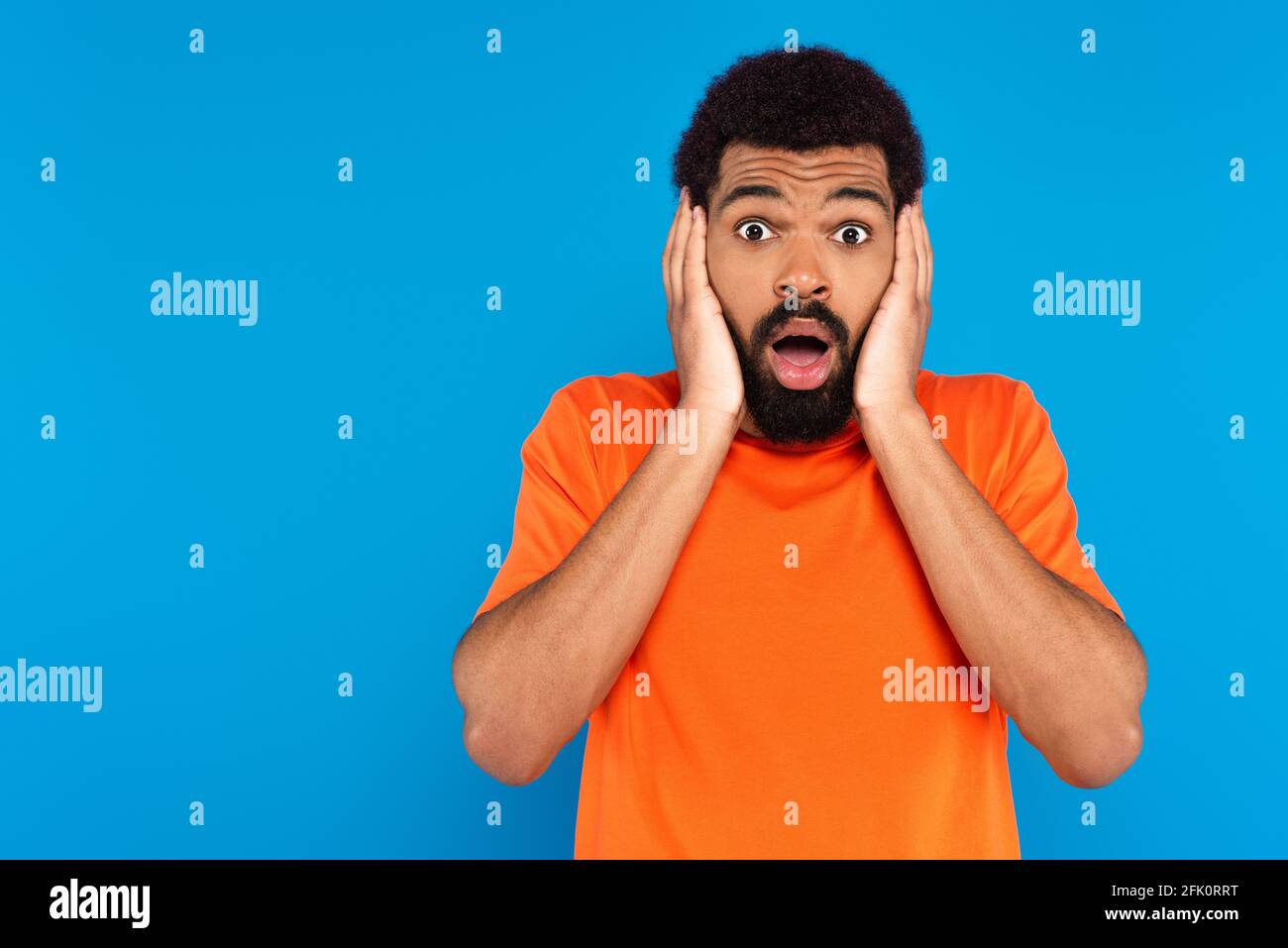 shocked african american man isolated on blue Stock Photo - Alamy