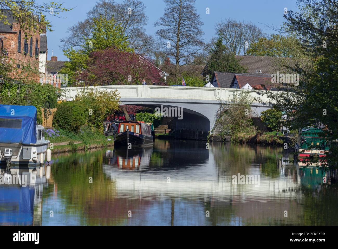 Canal narrowboats on the Bridgewater canal at Stockton Heath on a springtime afternoon by the London Road bridge on the A49. Stock Photo
