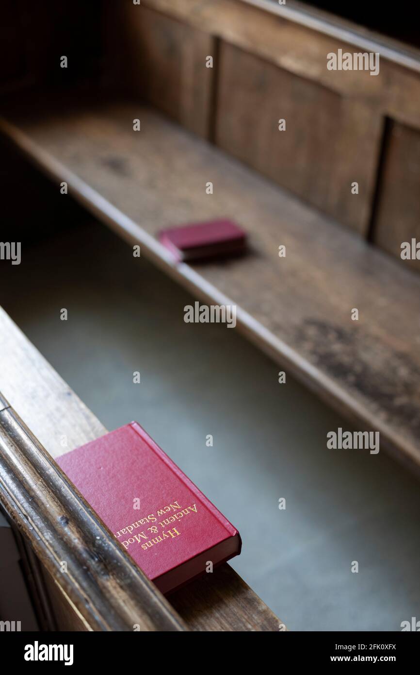 Hymn books in the pews, St Andrews Church, Eastleach, Cotswolds, Gloucestershire, England, United Kingdom, Europe Stock Photo