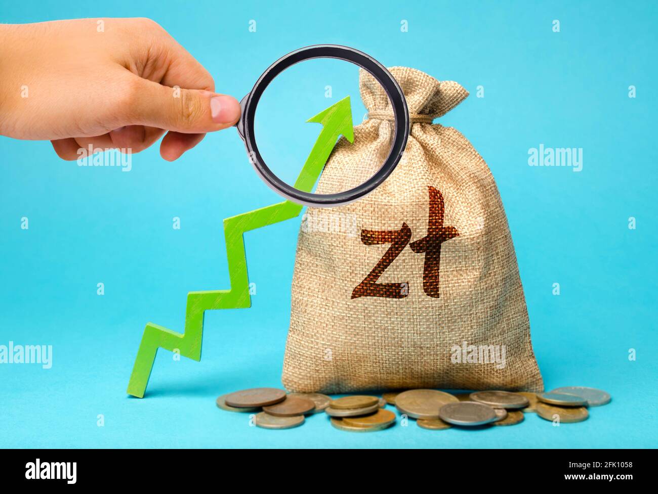 Polish zloty money bag and green arrow up. Growth of economy and increase of investment attractiveness. Developing markets. Business and finance conce Stock Photo