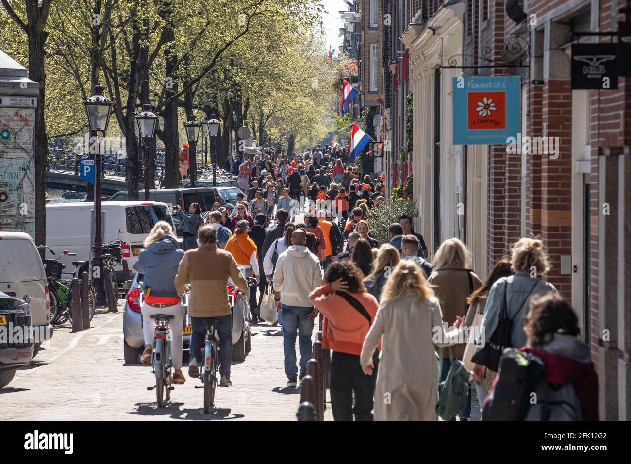 AMSTERDAM, NETHERLANDS - APRIL 27: Crowds of revelers are seen during King’s Day 2021 (Koningsdag) on April 27, 2021 in Amsterdam, Netherlands. Due to the coronavirus pandemic, this year’s official celebrations have all been cancelled just like last year. Still, many revelers went out on the streets of Amsterdam and other cities around the country. (Photo by Niels Wenstedt/BSR Agency/Alamy Live News) Stock Photo