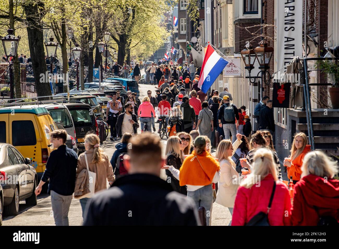 AMSTERDAM, NETHERLANDS - APRIL 27: Crowds of revelers are seen during King’s Day 2021 (Koningsdag) on April 27, 2021 in Amsterdam, Netherlands. Due to the coronavirus pandemic, this year’s official celebrations have all been cancelled just like last year. Still, many revelers went out on the streets of Amsterdam and other cities around the country. (Photo by Niels Wenstedt/BSR Agency/Alamy Live News) Stock Photo