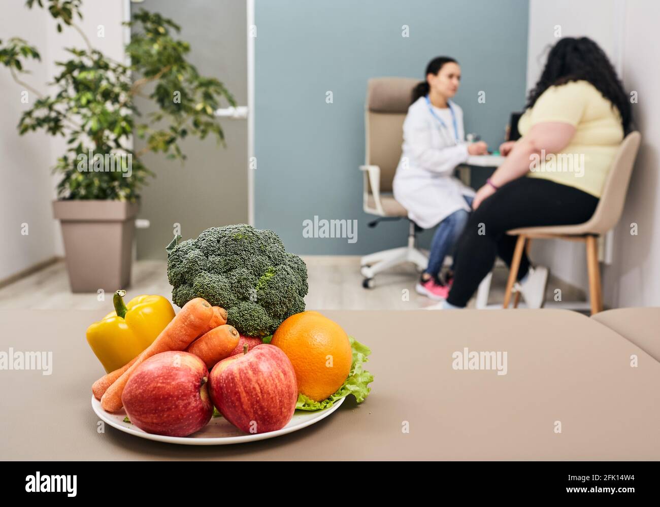 Healthy diet. Dietitian plans meal plan and diet to weight loss for a female obese patient Stock Photo