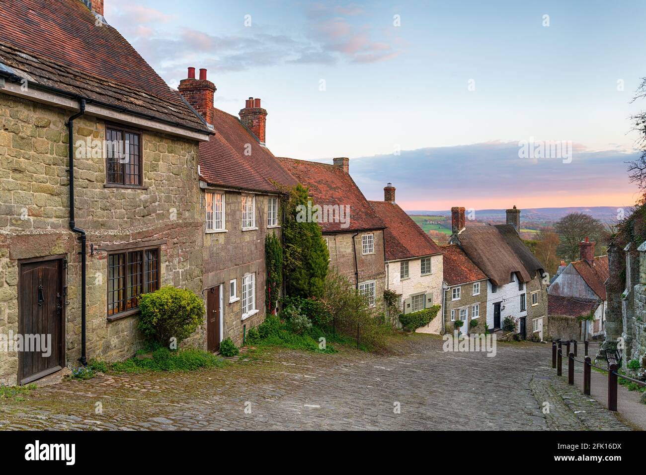 Sunset over cottages on a cobbled street at Gold Hill in Shaftestbury in Dorset Stock Photo