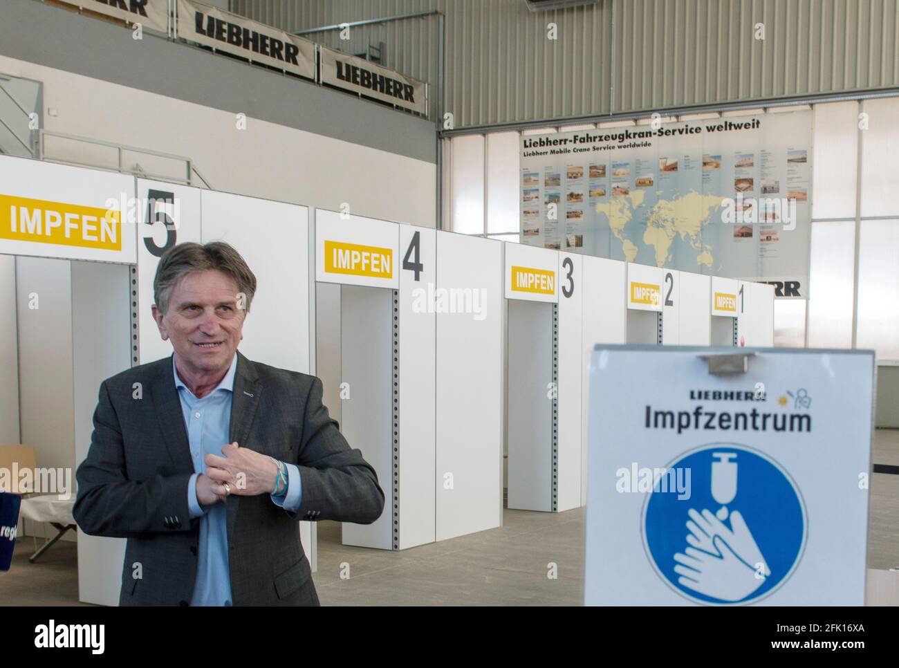 Ehingen, Germany. 27th Apr, 2021. Manfred (Manne) Lucha (Bündnis90/Die Grünen), Minister for Social Affairs and Integration of Baden-Württemberg, stands in the vaccination centre of the machine manufacturer Liebherr. The Liebherr plant in Ehingen was selected as a pilot plant for vaccinations by company doctors in Baden-Württemberg. The state's well-known vaccination prioritisation applies, so that employees aged 60 and over will be vaccinated as a first step. Credit: Stefan Puchner/dpa/Alamy Live News Stock Photo