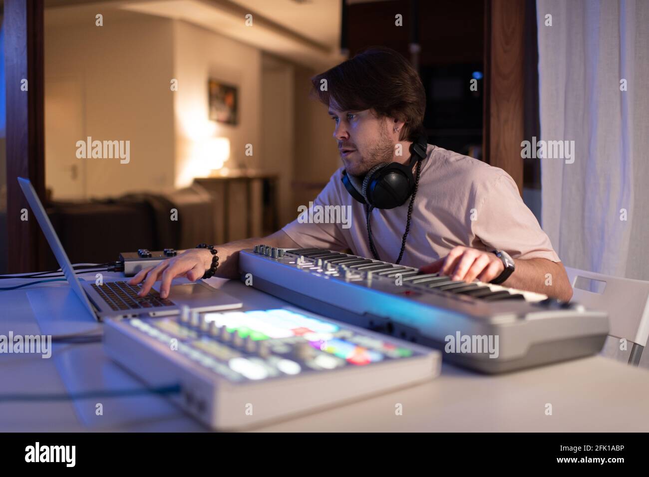 Male musician using laptop in home recording studio Stock Photo