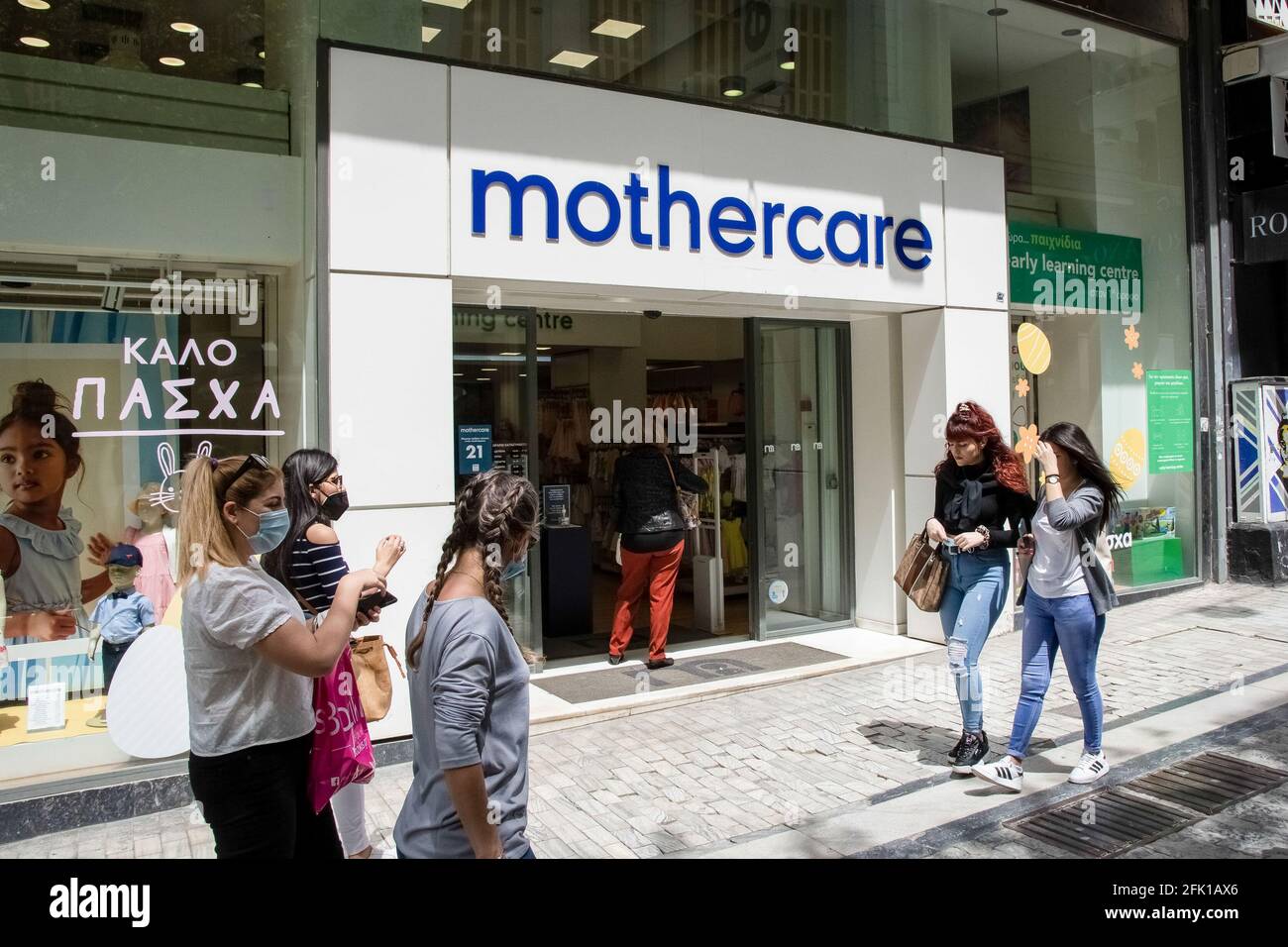People seen walking past a Mothercare store at Ermou street close to  Syntagma square Stock Photo - Alamy