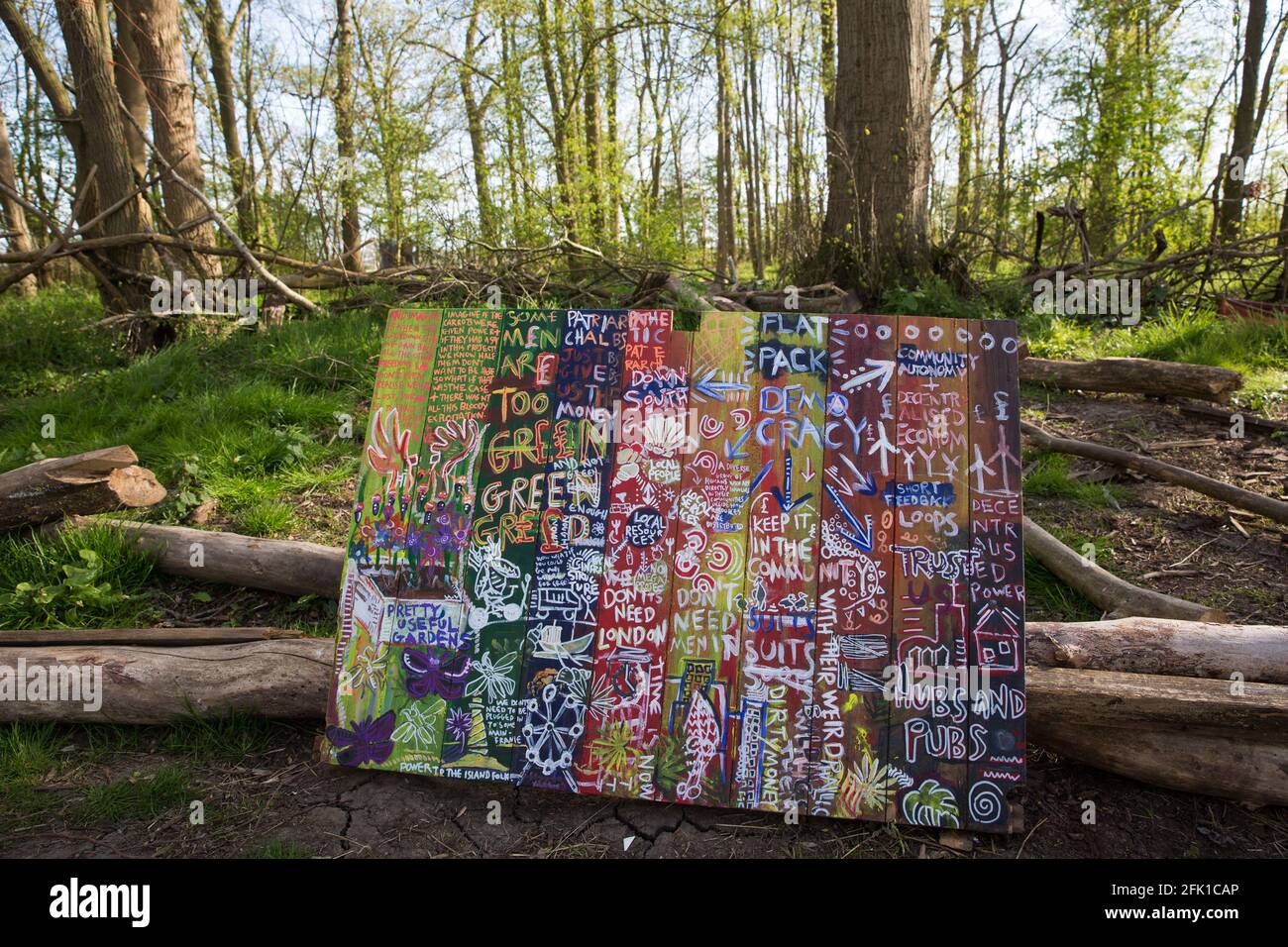 Steeple Claydon, UK. 26th April, 2021. Artwork is pictured in front of surviving woodland at Poors Piece. A strip of the woodland was removed by HS2 Ltd in February 2021. Poors Piece Protection Camp, set up in spring 2020 at the invitation of owner Clive Higgins, is one of several protest camps occupied by environmental activists in order to oppose the HS2 infrastructure project along its Phase 1 route between London and Birmingham. Credit: Mark Kerrison/Alamy Live News Stock Photo