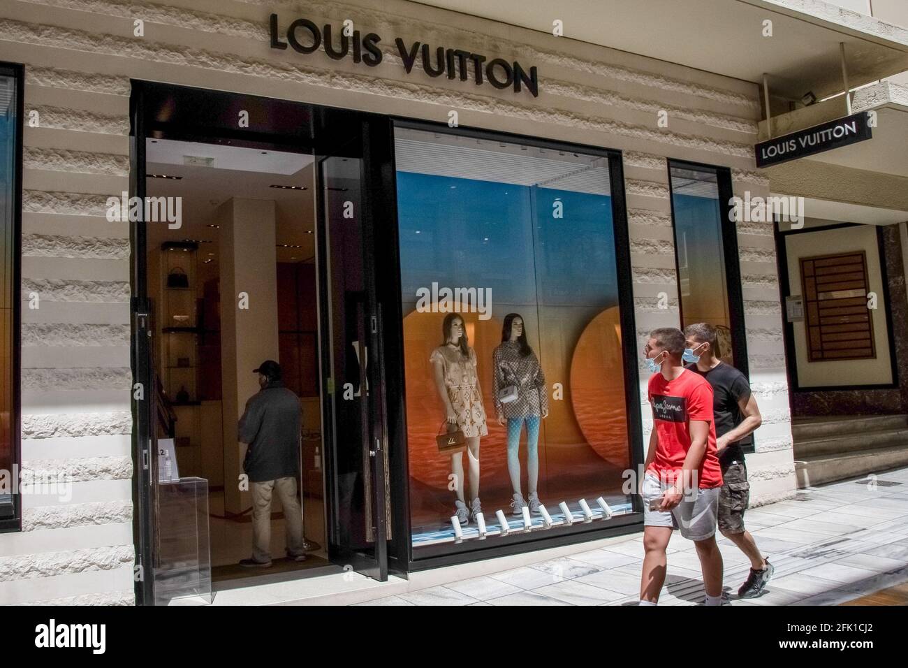 Athens, Greece. 27th Apr, 2021. People seen walking past a Louis Vuitton  store in the area