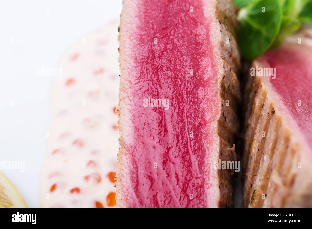 Grilled tuna fillet with corn salad and delicious sauce. Macro. Photo