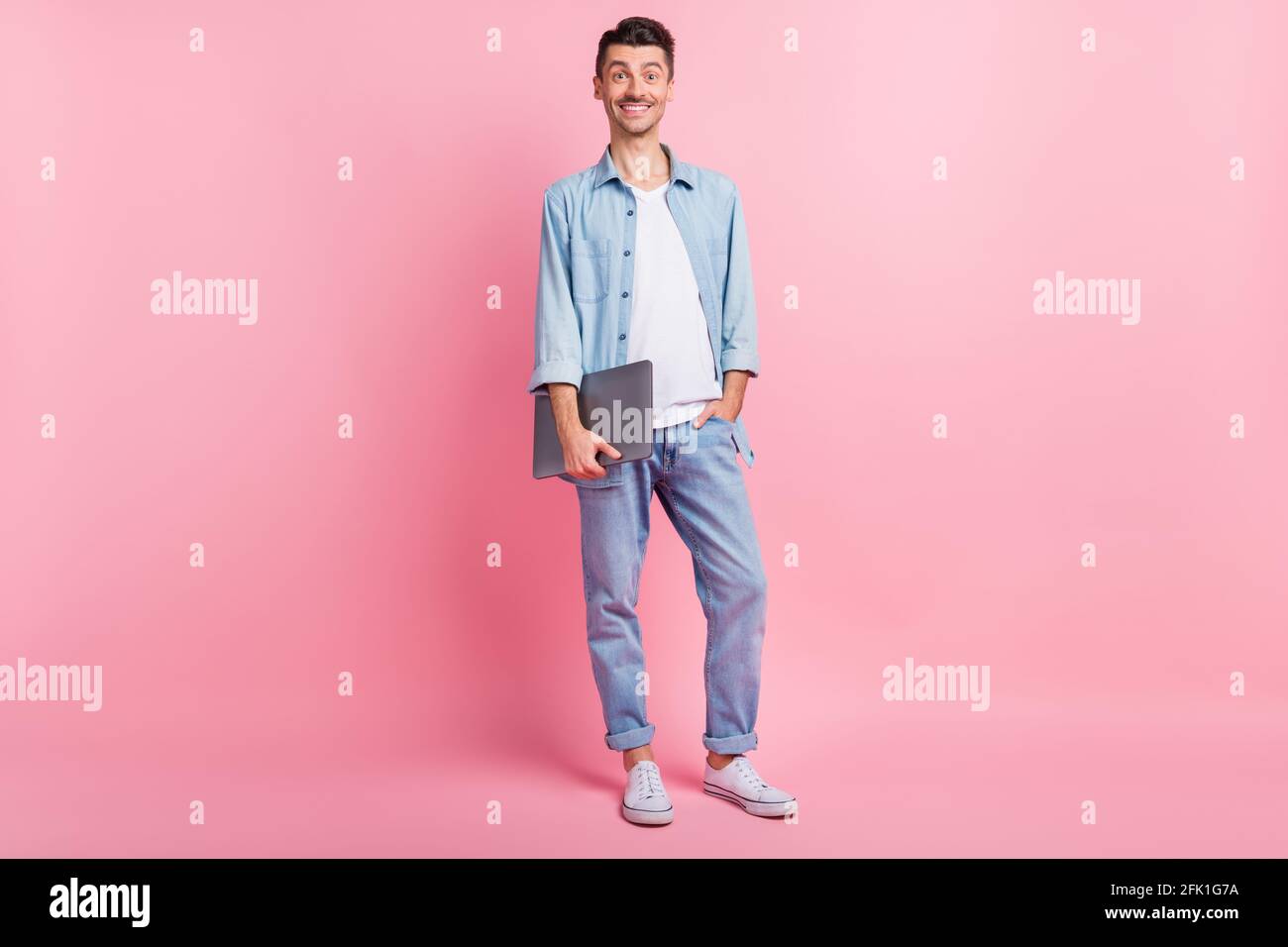 Full length body size photo of positive programmer holding computer ...