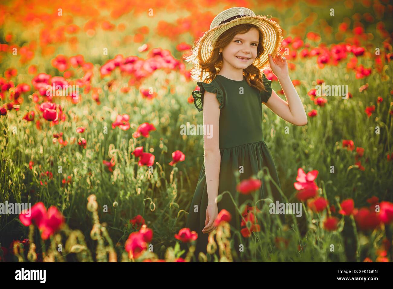 Girl in dress and straw hat outdoor At Poppy Field Stock Photo - Alamy