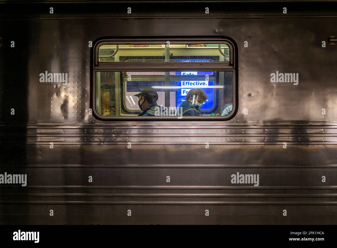 Masked riders on the subway in New York on Saturday, April 10, 2021. (© Richard B. Levine) Stock Photo