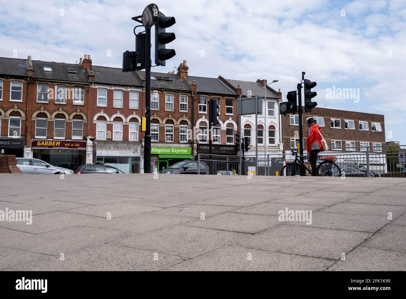 Kingston-Upon Thames London, April 27 2021, Single Cyclist Waiting At Red Traffic Lights Stock Photo