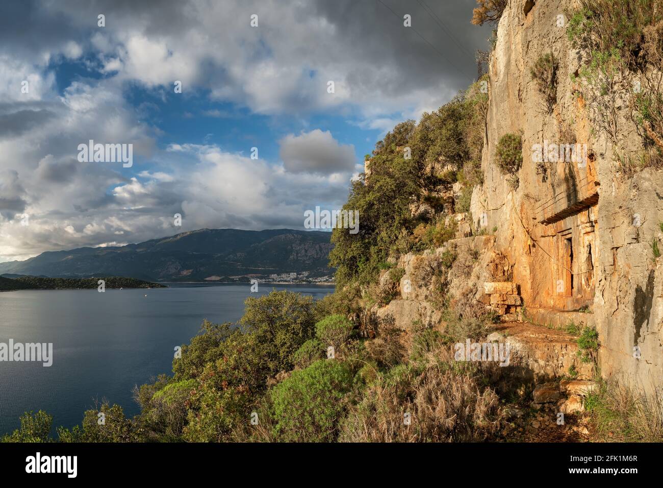 Ancient rock-cut Lycian tombs near Kas town on a Lycian way trekking route in Turkey Stock Photo