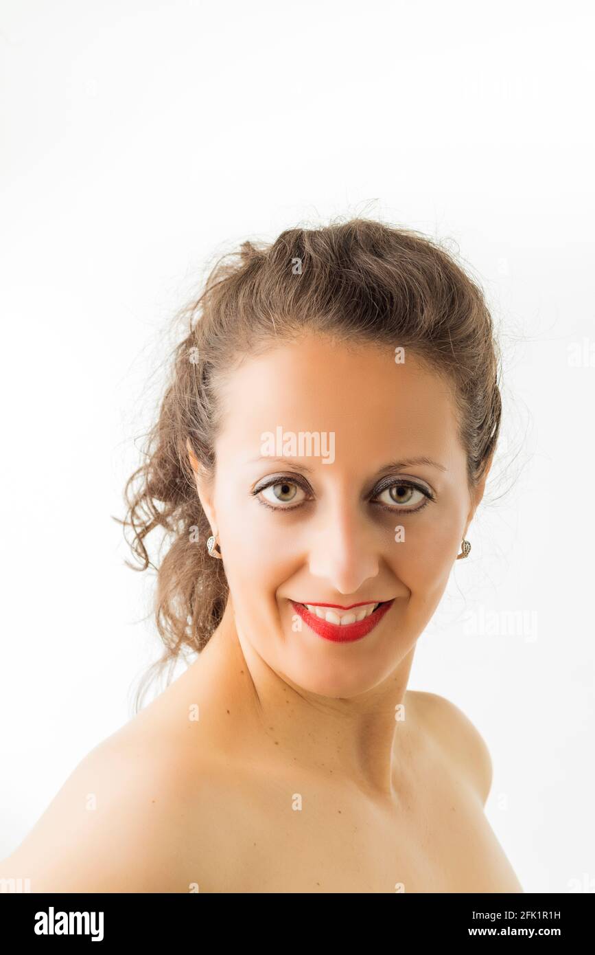Portrait of a Caucasian woman with red lips and collected hair, on white background. Stock Photo