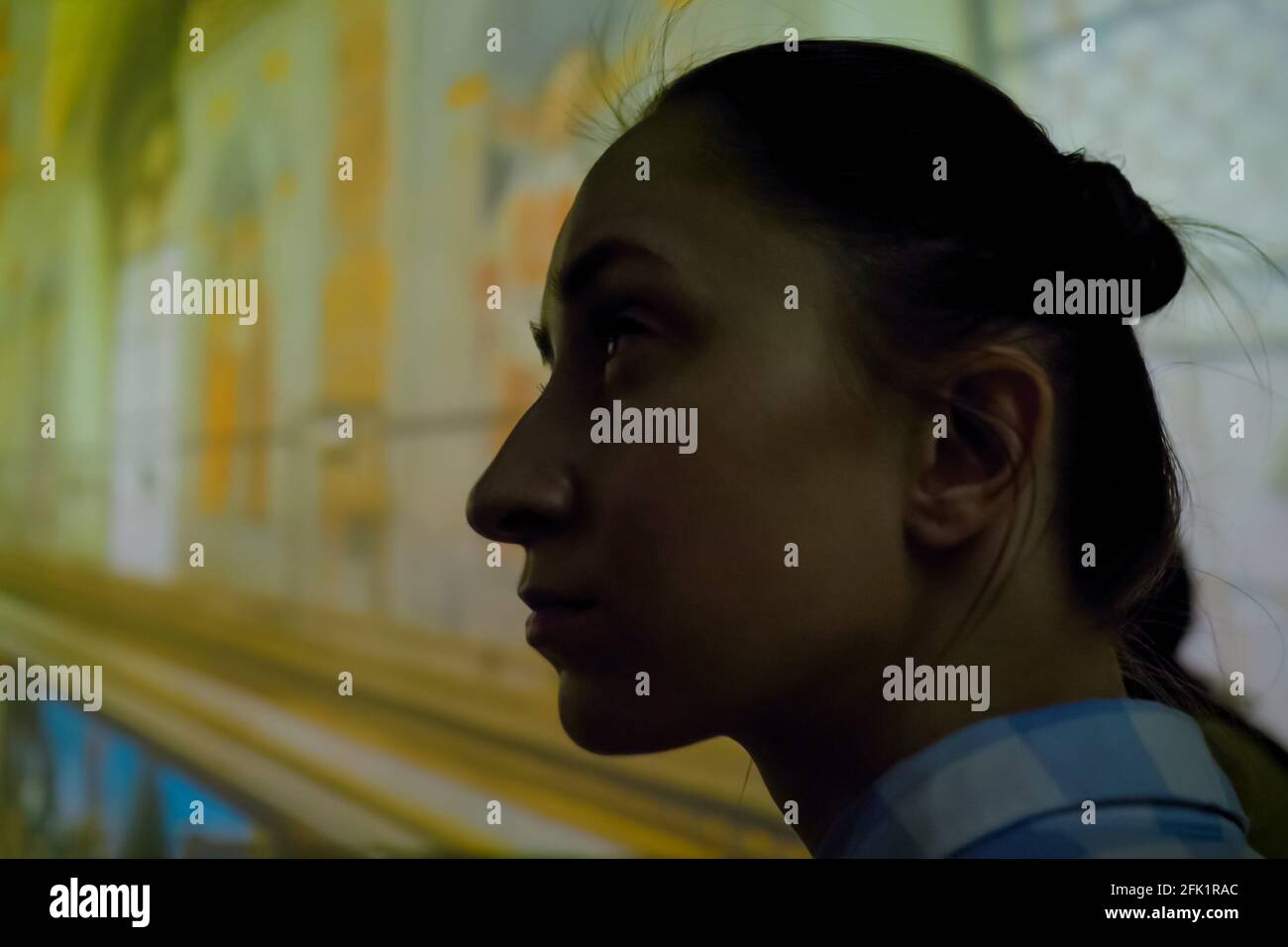 Young woman looking around at immersive exhibition - video art installation Stock Photo